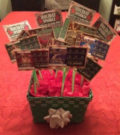 Lottery ticket gift basket made with scratch-off tickets on sticks sticking out of tissue-paper filled basket.