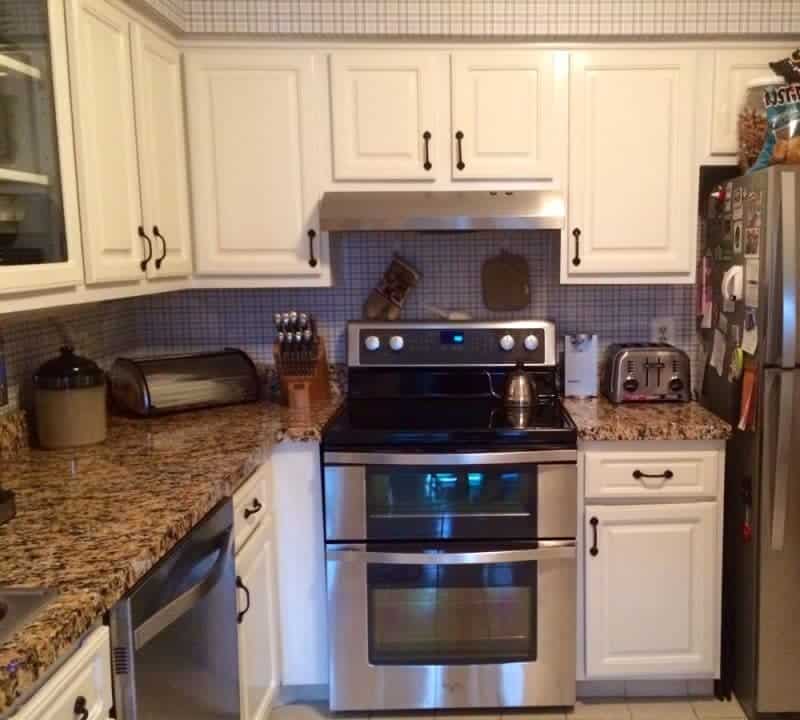 Kitchen with faux granite countertop film installed.