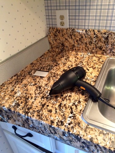 Blow dryer on countertop.