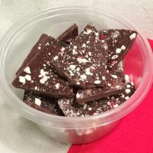 Peppermint chocolate bark in plastic container.
