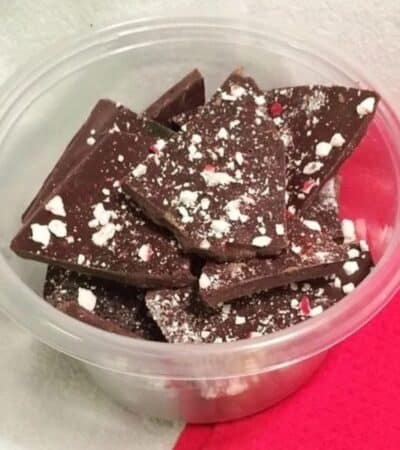 Peppermint chocolate bark in plastic container.
