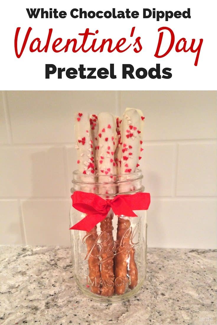 White chocolate dipped Valentine's Day pretzel rods with heart sprinkles.
