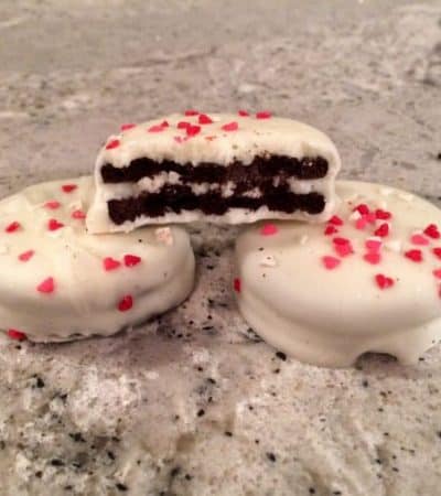 White Chocolate Covered Valentine's Day Oreos with heart sprinkles.