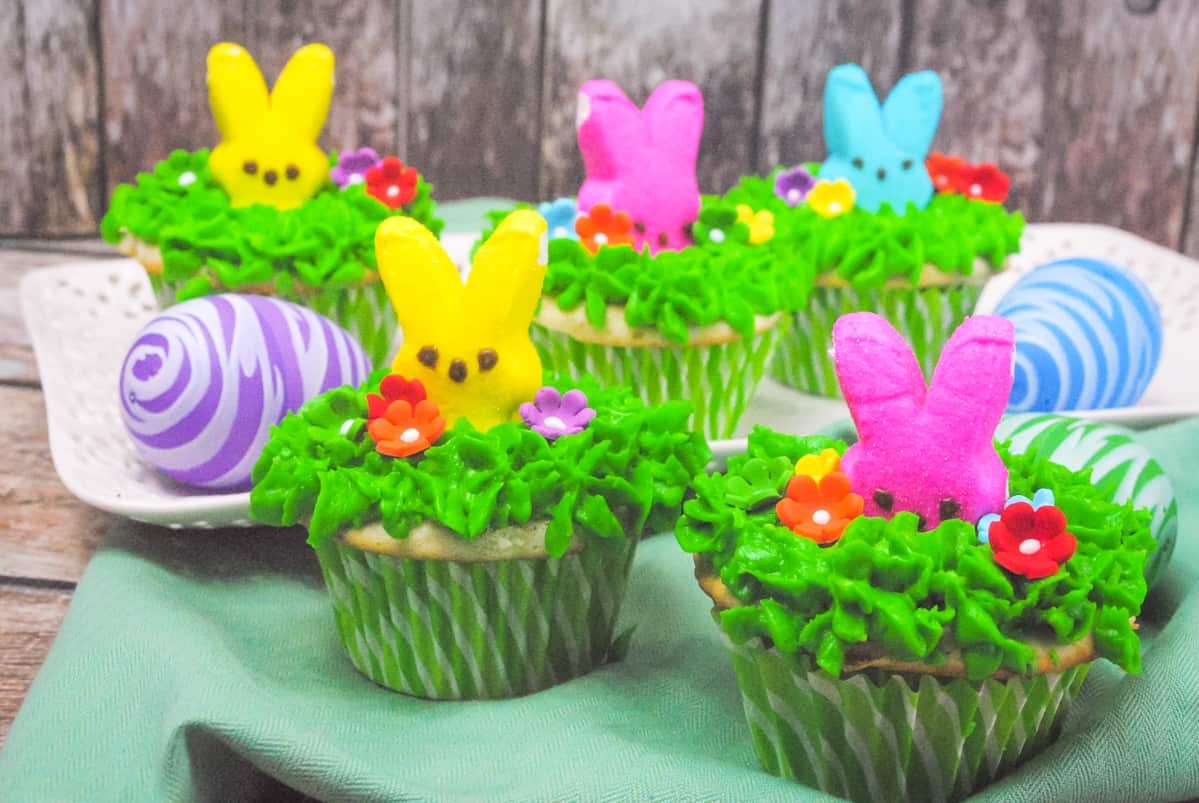 Peeps bunny cupcakes with buttercream frosting dyed green and piped on to look like grass.