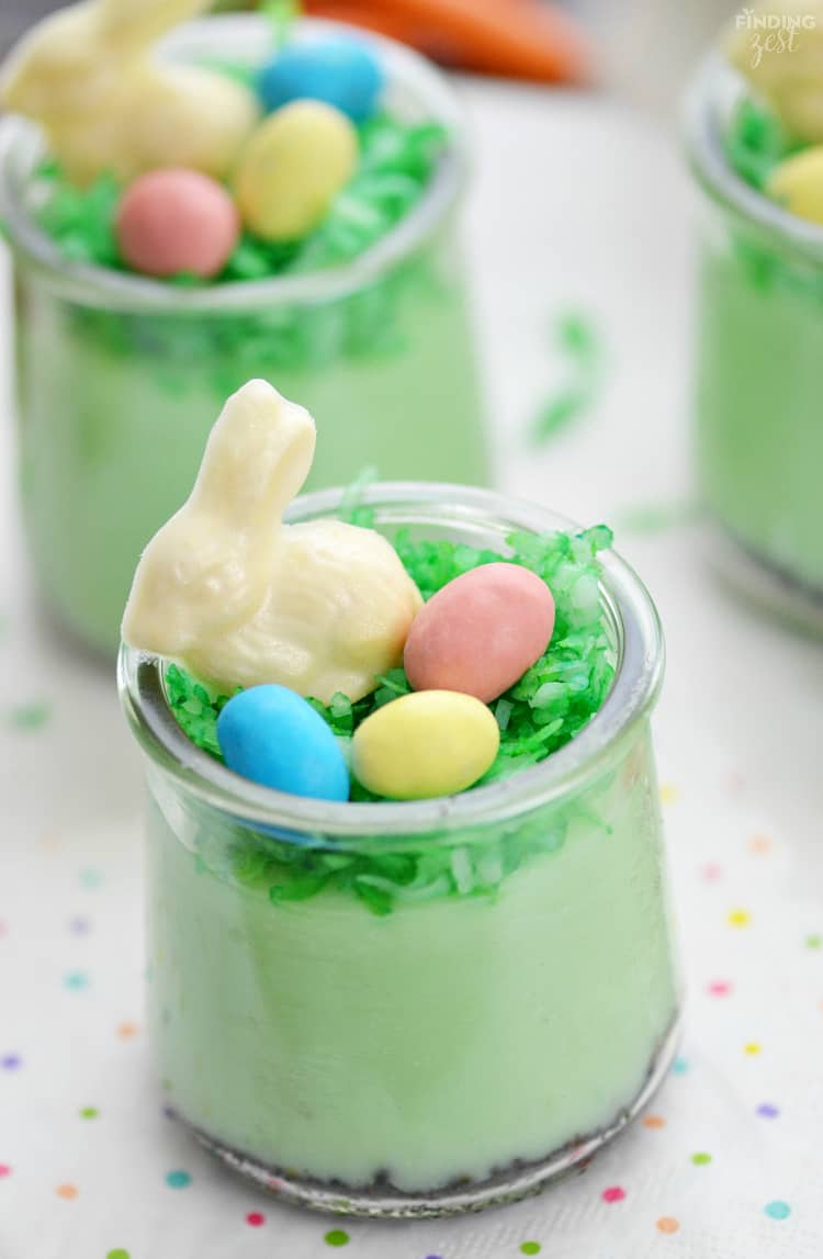 Pistachio Pudding Parfaits topped with chocolate bunnies and candy eggs.