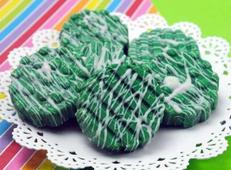 St. Patrick's Day Oreos covered in green chocolate and a white drizzle.