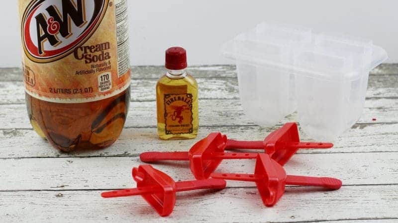 A&W Cream Soda 2 litter bottle, small Fireball Whiskey bottle, and 4 cavity ice pop mold.