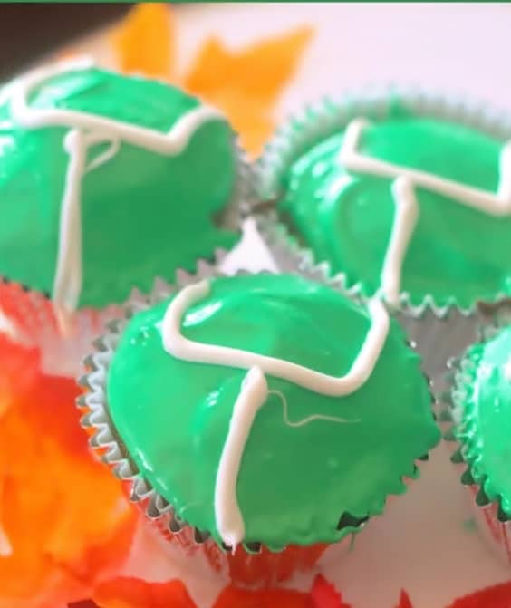 Easy game day cupcakes decorated with green icing and white goalposts