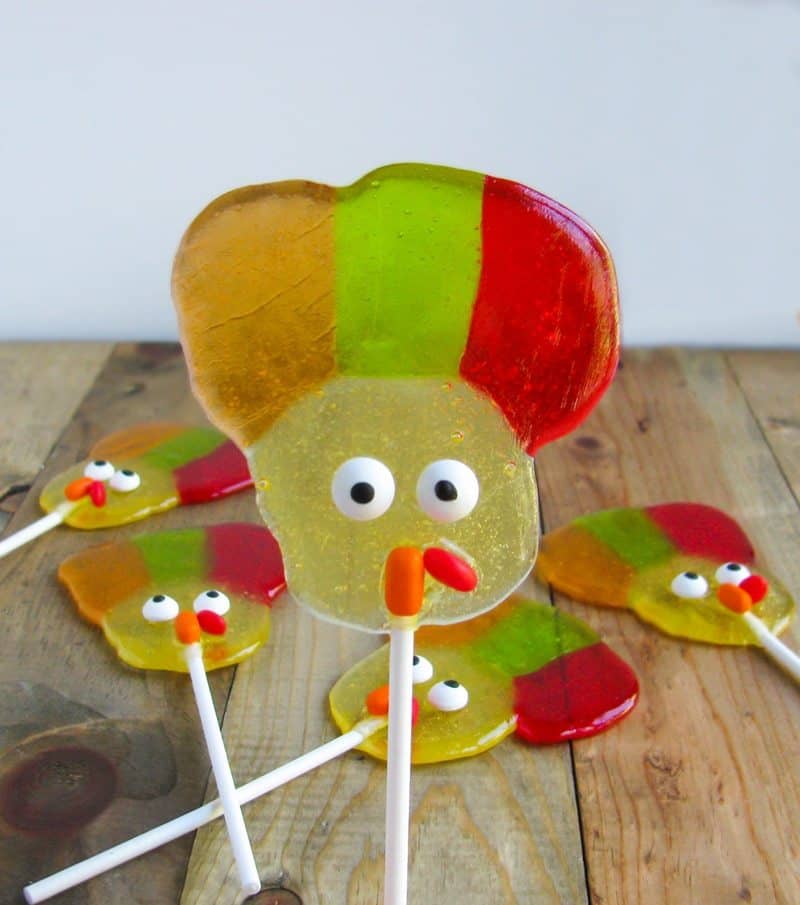 Turkey shaped lollipops with candy eyes, orange tic tac nose, and red hot wattle.
