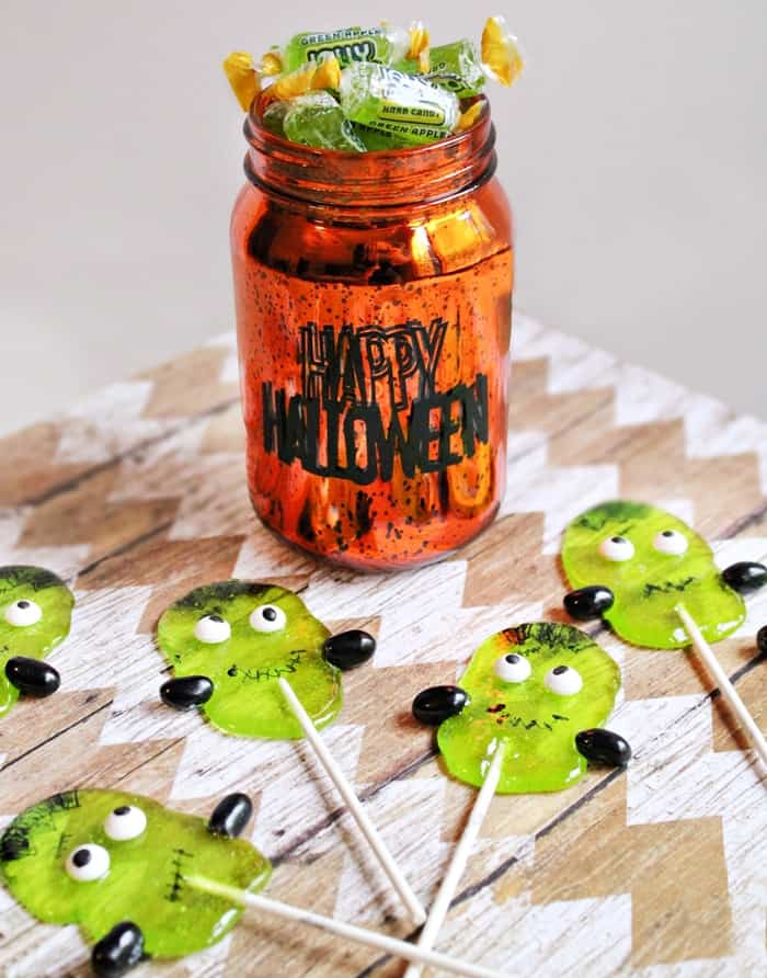 You don't need lightning or a fancy laboratory to make these adorable Halloween creations. These cute Frankenstein Suckers are made using Green Apple Jolly Ranchers!