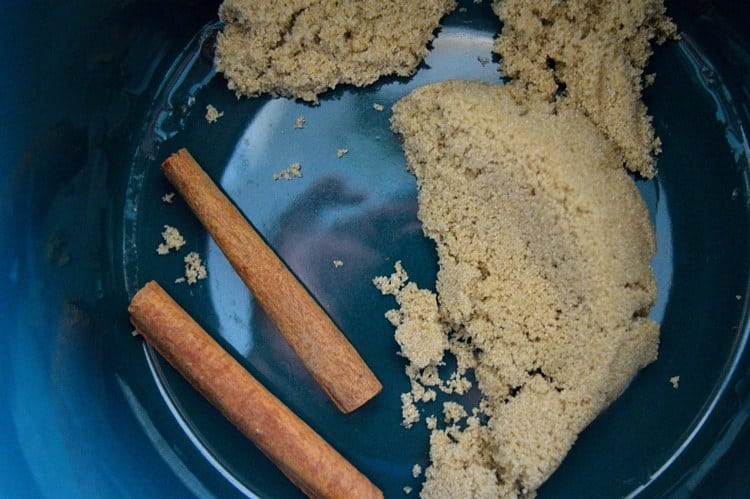 Cinnamon sticks and brown sugar in crockpot.