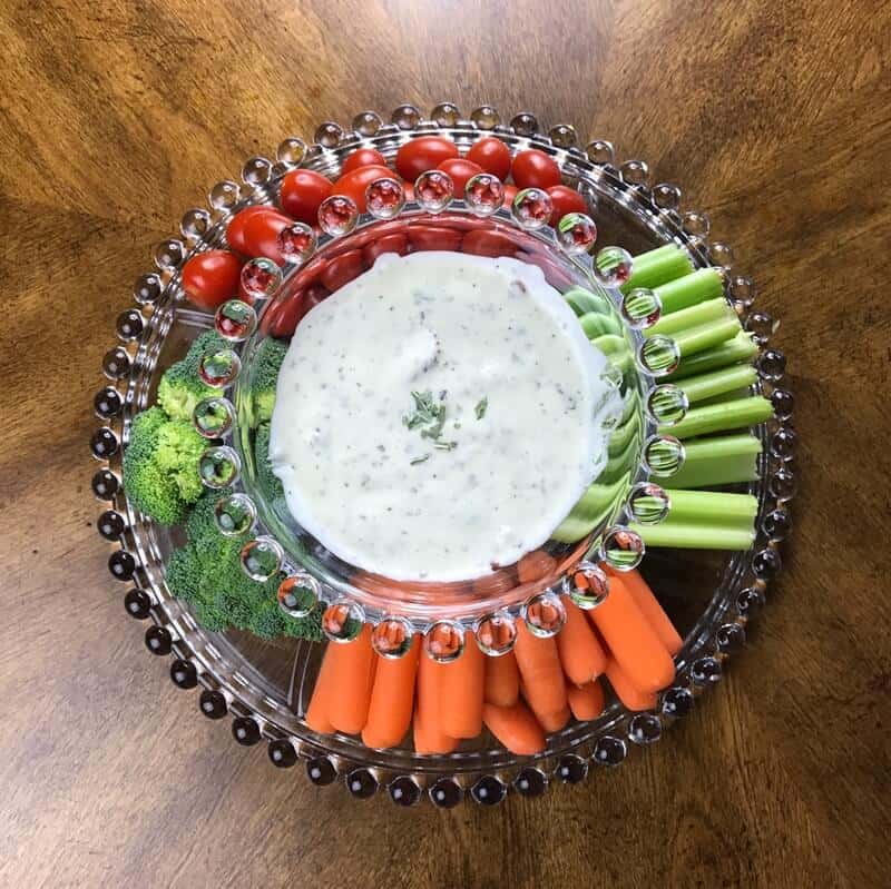 Bacon ranch dip surrounded by fresh veggies for dipping.