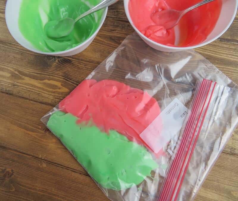 Green and red pudding spooned into large freezer bag.