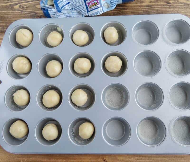 Sugar Cookie dough balls in greased mini muffin tin.