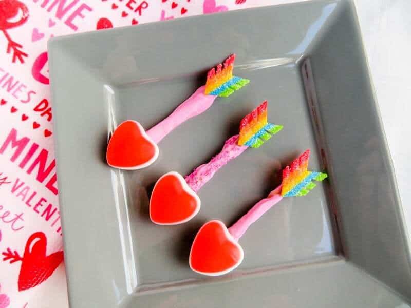 Three candy arrows on gray plate.