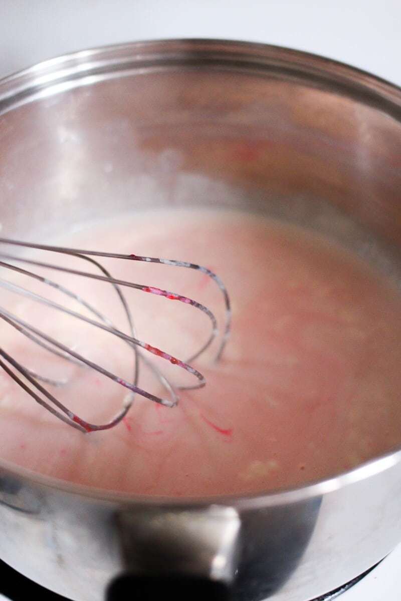 Whisk in bowl of pink velvet chocolate mixture.