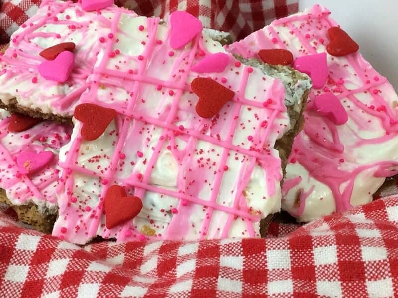 Valentine's Day bark candy made with graham crackers, white and pink melted chocolate, and sprinkles.