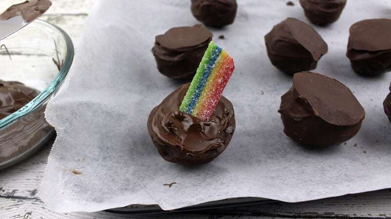 Rainbow candy pressed into melted chocolate on the top of the oreo truffle.