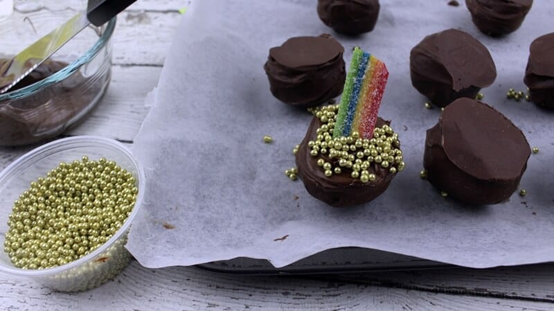 Pot of gold truffles with gold balls added to cover the remaining melted chocolate.