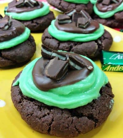 Grasshopper cookies topped with green frosting, melted chocolate, and chopped andes mint candies.