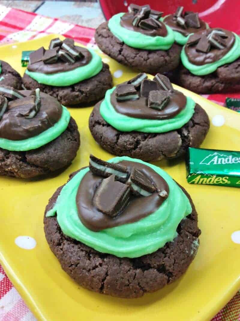 Grasshopper cookies topped with green frosting, melted chocolate, and chopped andes mint candies.