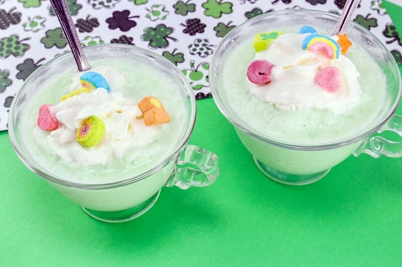 St. Patric's Day Shamrock Frozen White Hot Chocolate topped with lucky charms marshmallows and cool whip.