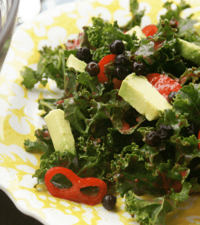 Blueberry Kale Salad with avocado, chili peppers, and a raspberry lime vinaigrette.