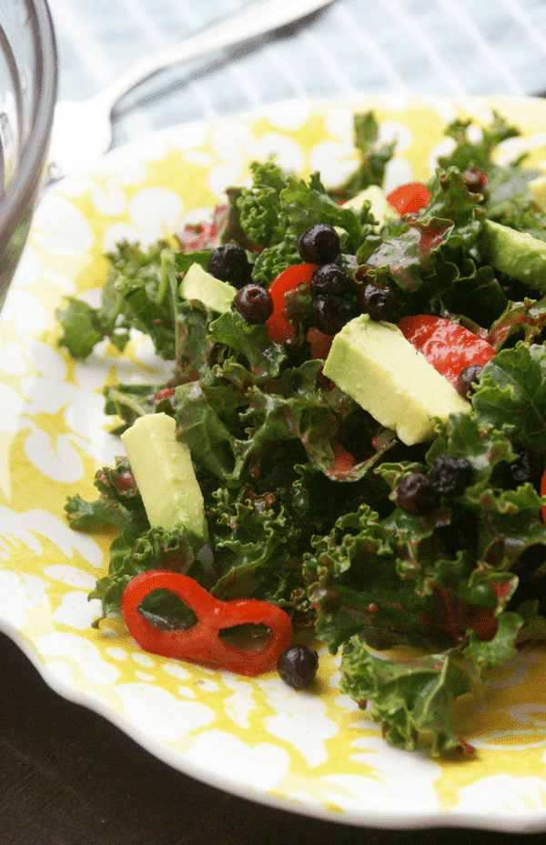 Blueberry Kale Salad with avocado, chili peppers, and a raspberry lime vinaigrette. 