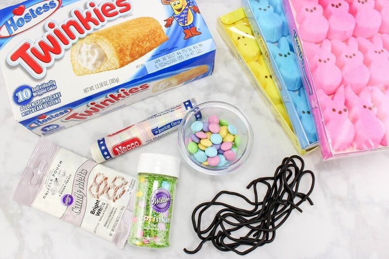 Peeps Twinkie car ingredients: Easter Peep candies, Twinkies, pastel M&Ms, white candy melts, easter sprinkles, black licorice ropes, and Necco wafer candies.