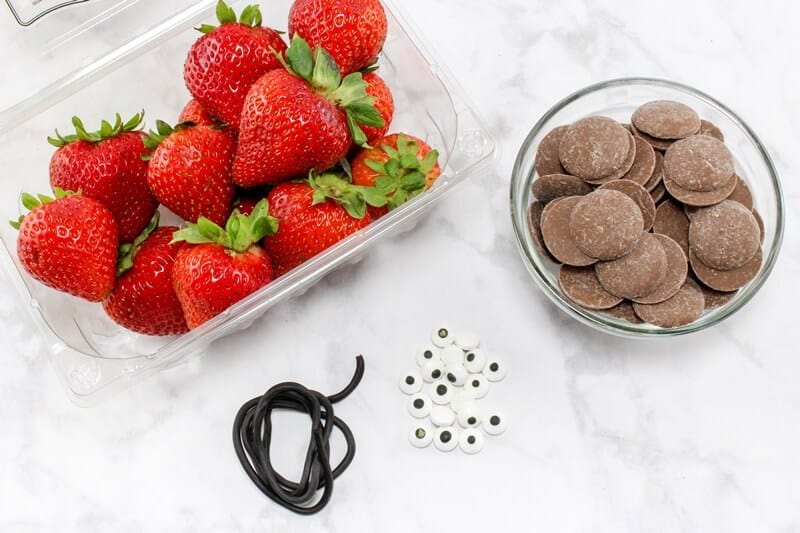 Strawberry Ladybug Snacks Ingredients: fresh strawberries, chocolate candy melts, black licorice rope, edible eyes.