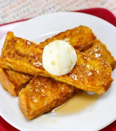 Pumpkin french toast sticks served with butter and syrup.