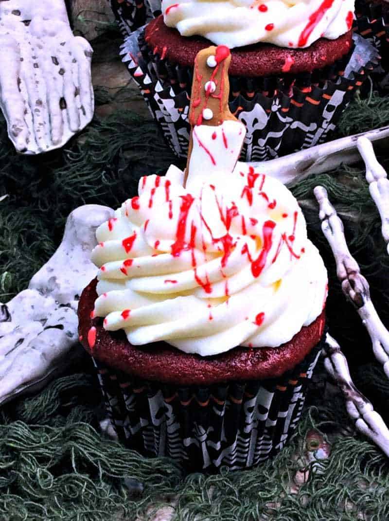 Blood splatter cupcakes with edible blood splatted on top.