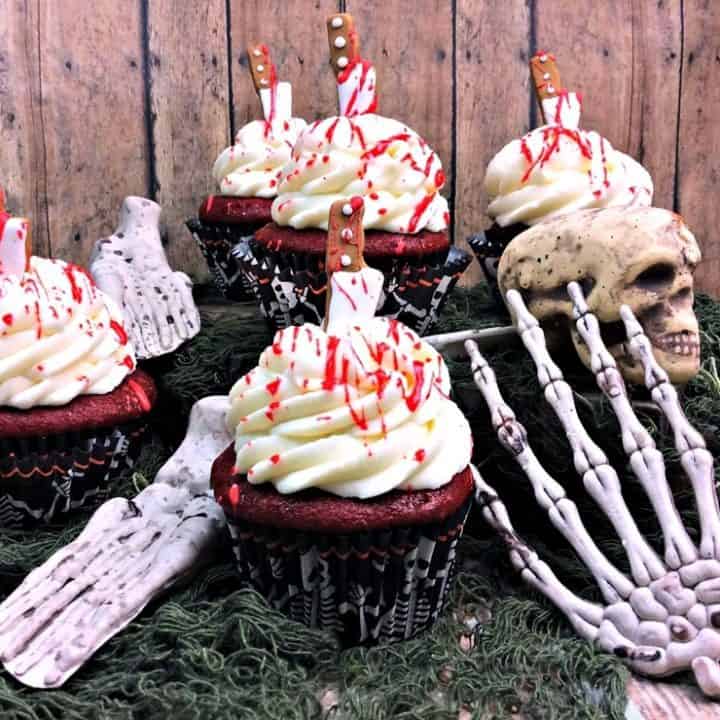 These gruesome bloody cupcakes are stabbed with a knife and dripping with blood. A perfect dessert for your Halloween, Zombie, or Walking Dead party.