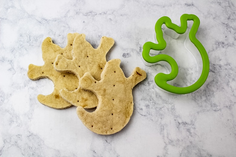 Ghost cookie cutter and three ghost-shaped pizza crusts.