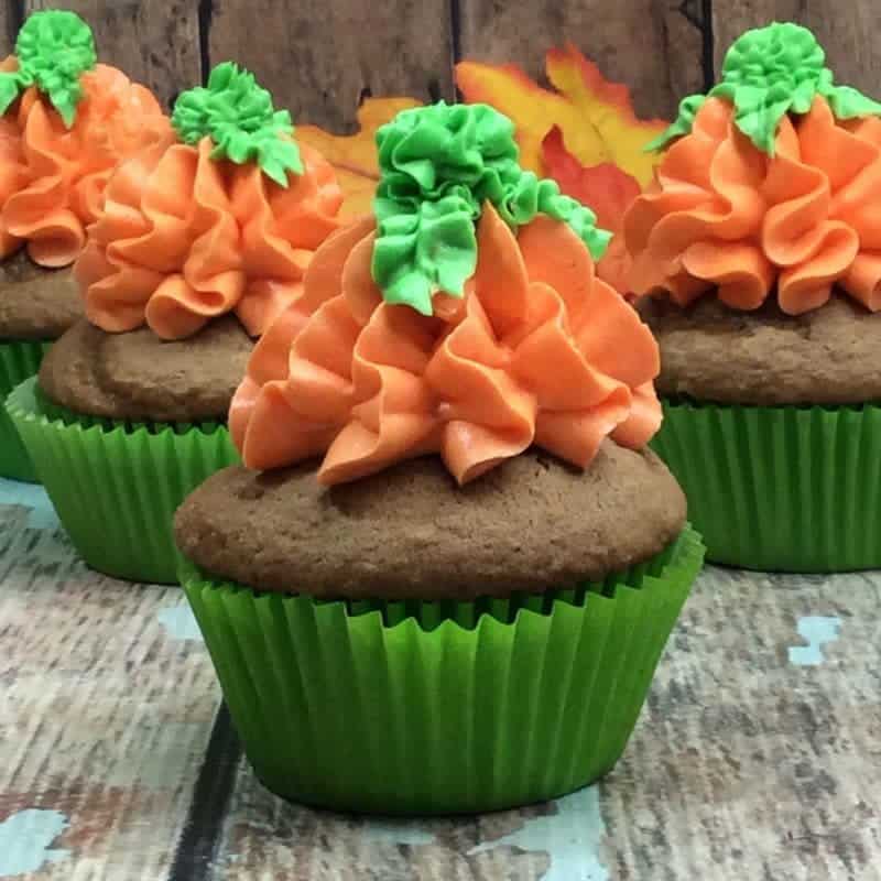 Pumpkin spice cupcake with buttercream frosting piped on to resemble a pumpkin.