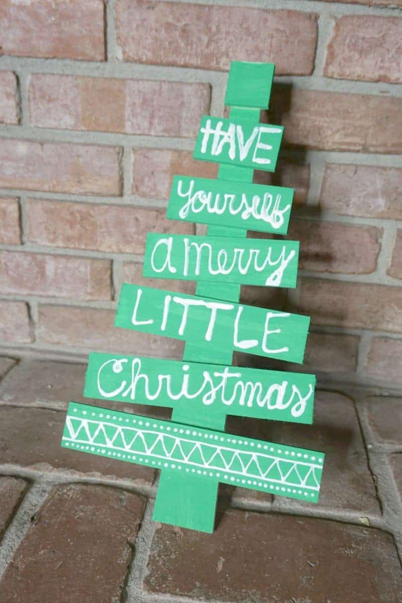 This DIY holiday phrase wooden Christmas tree is the perfect easy DIY Christmas decoration idea. It will make a great addition to your holiday decor.