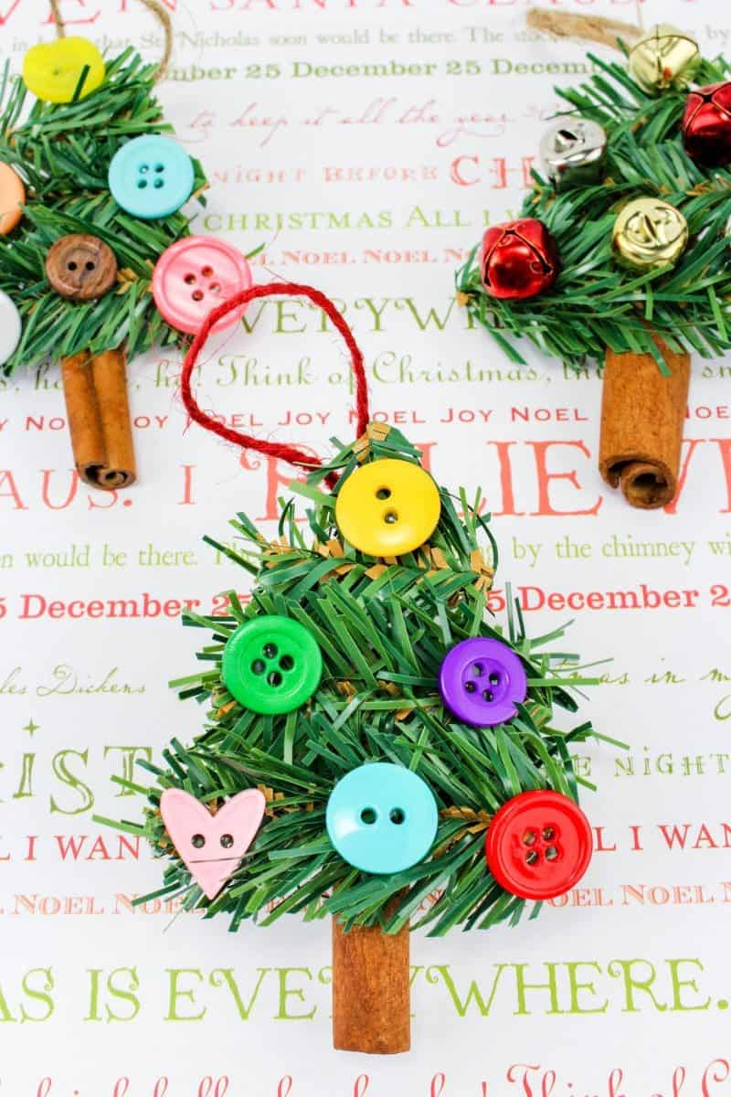 A fun DIY Christmas Tree Ornament craft, made using wreath garland, cinnamon sticks, twine, buttons, pom poms and jingle bells.