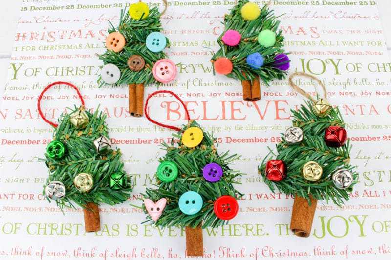 A fun DIY Christmas Tree Ornament craft, made using wreath garland, cinnamon sticks, twine, buttons, pom poms and jingle bells.