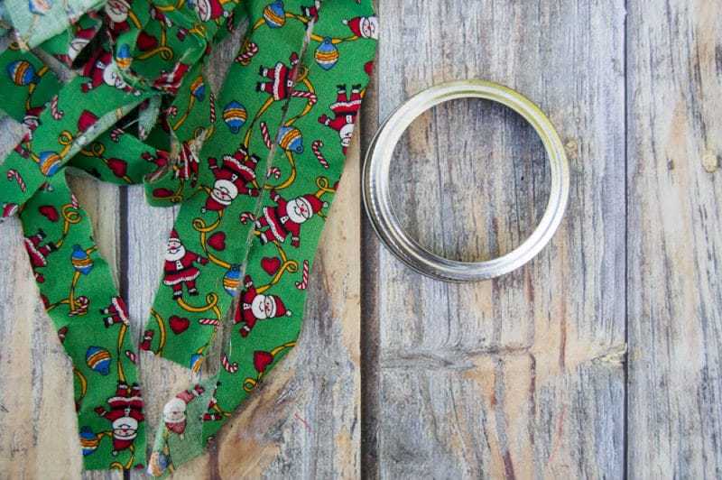 Mason canning jar lid Christmas wreath ornaments are great  for giving your tree that homemade rustic feel, and can be customized with any color fabric.