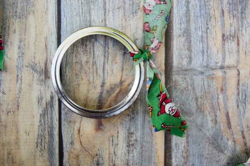 Mason canning jar lid Christmas wreath ornaments are great  for giving your tree that homemade rustic feel, and can be customized with any color fabric.