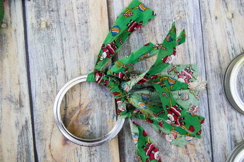 Mason canning jar lid Christmas wreath ornaments are great  for giving your tree that homemade rustic feel, and can be customized with any color fabric.