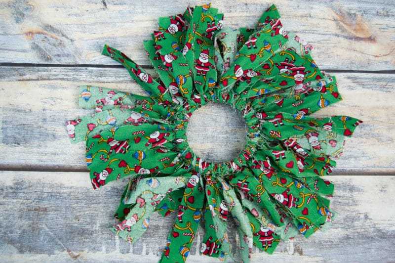 Mason canning jar lid Christmas wreath ornaments are great  for giving your tree that homemade rustic feel, and can be customized with any color fabric.