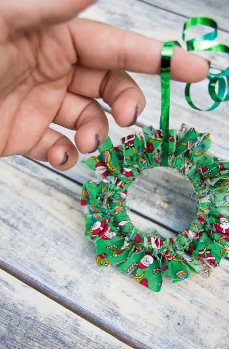 Mason canning jar lid Christmas wreath ornaments are great  for giving your tree that homemade rustic feel, and can be customized with any color fabric.