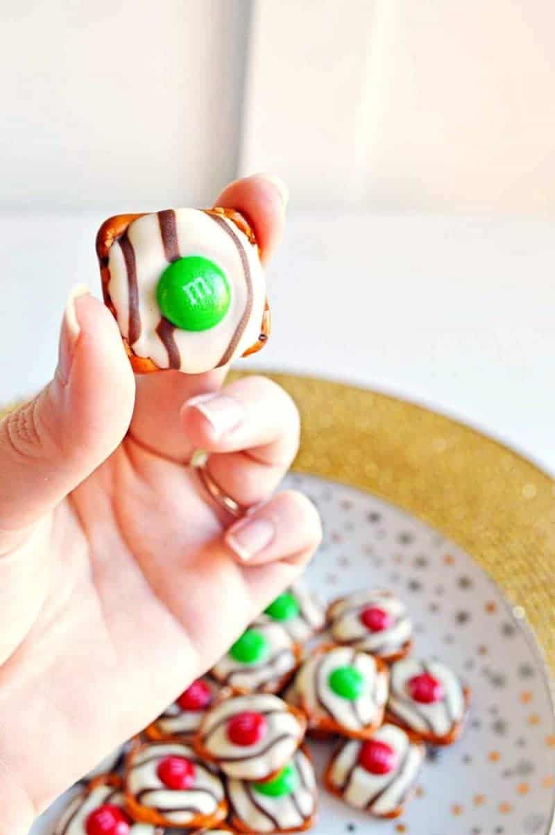 Salty-sweet Christmas pretzel hugs treats are quick and easy to make with just 3 ingredients: square pretzels, M&Ms, and Hershey's Hugs.