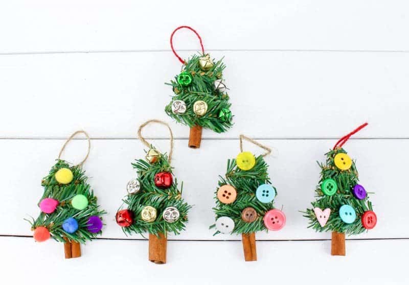 A fun DIY Christmas Tree Ornament craft, made using wreath garland, cinnamon sticks, twine, buttons, pom poms and jingle bells.