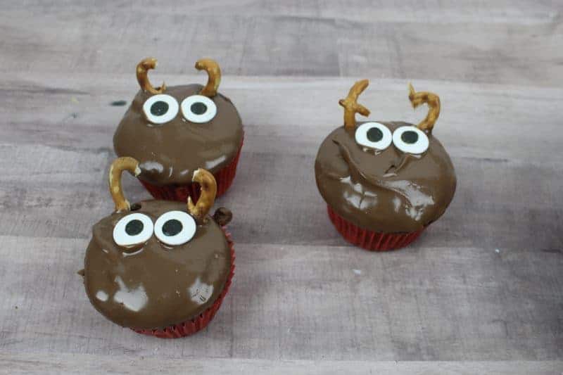 These cute Christmas reindeer cupcakes are ridiculously easy to make by decorating chocolate cupcakes with M&Ms, pretzels, and candy eyes.