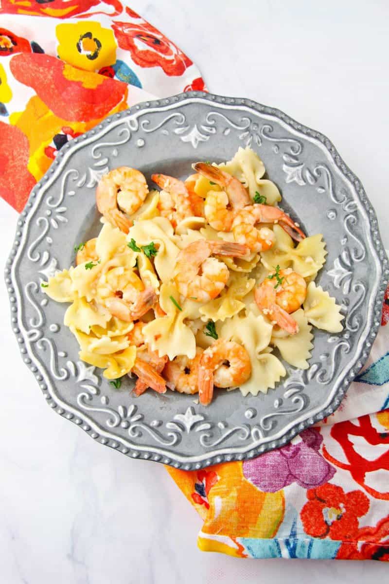 This delicious and simple instant pot shrimp scampi recipe takes minutes to make and can be served over pasta or rice for a quick and tasty dinner.
