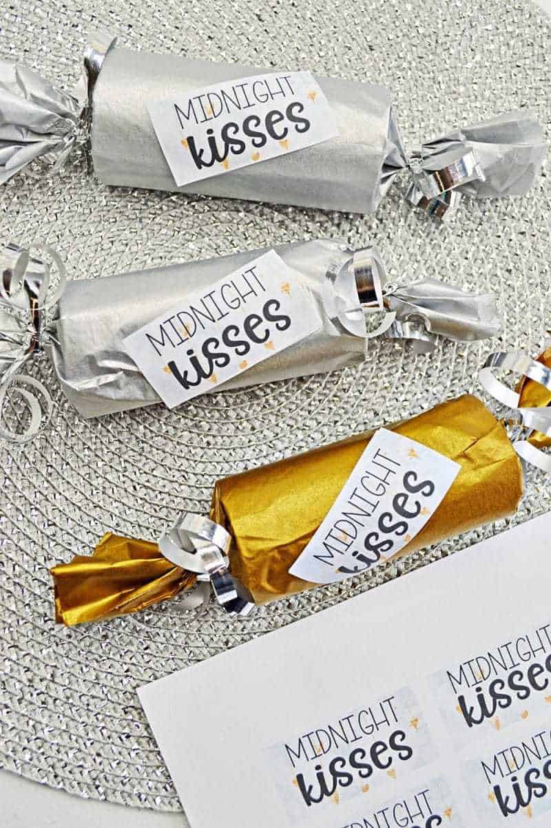 This fun Midnight Kisses New Year's Eve Party Poppers craft is easy to make with toilet paper rolls, tissue paper, ribbon, and the included printable label.