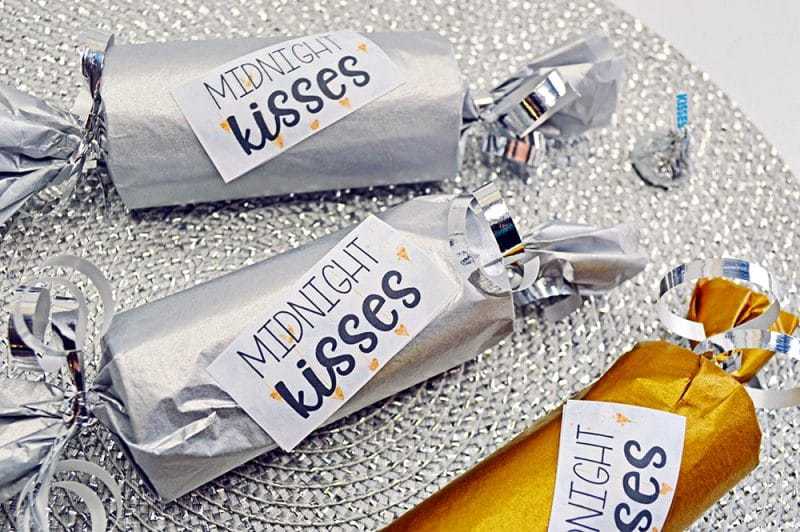 This fun Midnight Kisses New Year's Eve Party Poppers craft is easy to make with toilet paper rolls, tissue paper, ribbon, and the included printable label.
