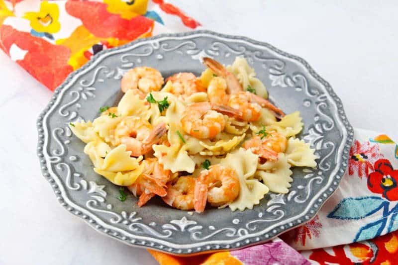 This delicious and simple instant pot shrimp scampi recipe takes minutes to make and can be served over pasta or rice for a quick and tasty dinner.
